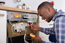 Technician testing the electrical components inside a dishwasher door